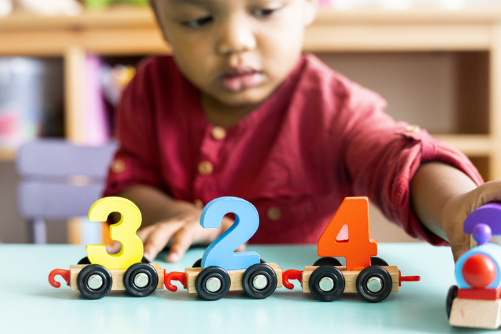 childcare in Ohio Little boy playing mathematics wooden toy at nursery